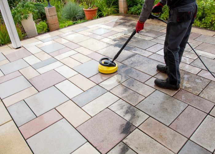 cleaning stone slabs on patio with the high pressure cleaner.